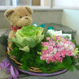 Floral Basket Arrangements with 1 Brassica, Carnation Sprays & Bear (8 inches)