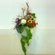 Congratulatory Floral Arrangement with 1 Brassica, 2 Sunflowers, 5 Bord of Paradise, 5 Gerberas & 5 Dendrobiums
